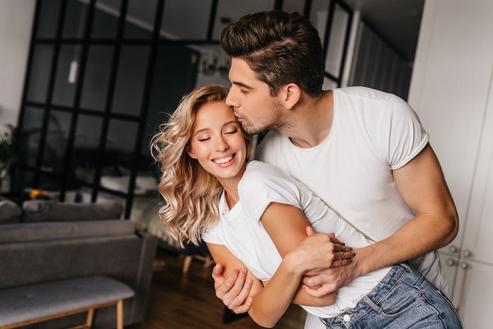 Romantic guy kissing wife